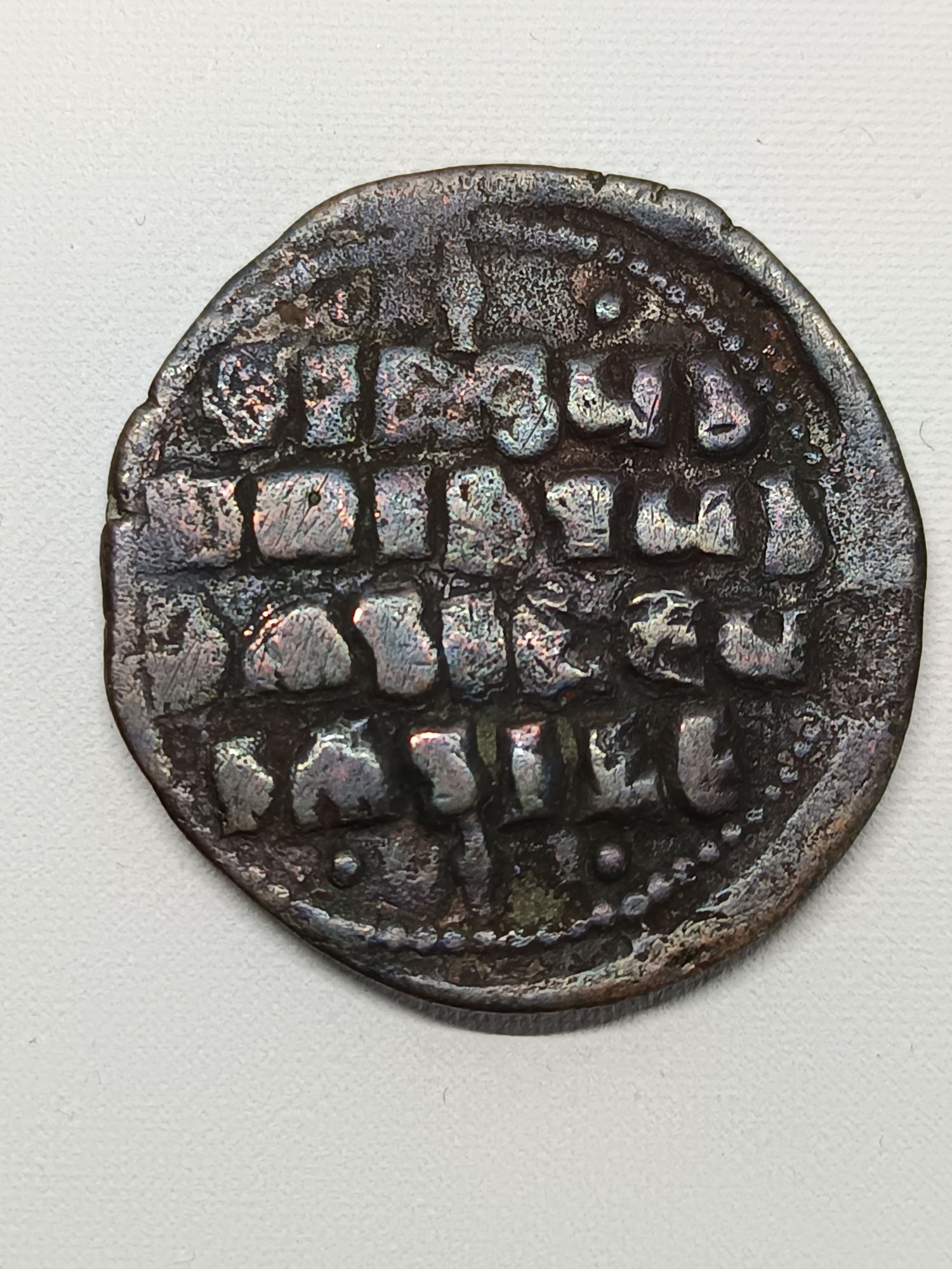 Le follis de l'empereur byzantin Basile II est une monnaie de bronze qui a été frappée à Constantinople entre 976 et 1028. Ces pièces sont souvent qualifiées de "follis anonymes de classe A2", car elles ne portent pas le portrait de l'empereur, mais une représentation du Christ. Voici les caractéristiques principales de cette monnaie : * Avers : Buste du Christ Pantocrator de face, avec un nimbe crucifère (auréole en forme de croix). Le Christ porte le pallium et le colobium et tient dans ses mains les Évangiles. Les lettres IC et XC sont inscrites de chaque côté. La légende est "+ EMMA NOVHA" (Emmanuel). * Revers : Une inscription en quatre lignes : "+ IhSUS XRISTUS bASILEU bASILE". Cela se traduit par "Jésus-Christ, Roi des Rois". Cette légende est souvent encadrée d'ornements au-dessus et en dessous. * Période de frappe : Principalement associée au règne de Basile II et de son frère Constantin VIII, de 976 à 1028. * Métal : Bronze. * Atelier : Constantinople. * Poids et diamètre : Le poids et le diamètre peuvent varier, car les flans étaient souvent irréguliers. On peut trouver des pièces allant de 9 à 19 grammes et de 28 à 34 mm. * Référence : La référence numismatique pour ce type de follis est généralement Sear 1813. Les follis de Basile II sont relativement courants pour les collectionneurs de monnaies byzantines, mais leur valeur peut varier considérablement en fonction de leur état de conservation (qualité du relief, lisibilité des légendes) et des particularités de la pièce (variantes des ornements, etc.).